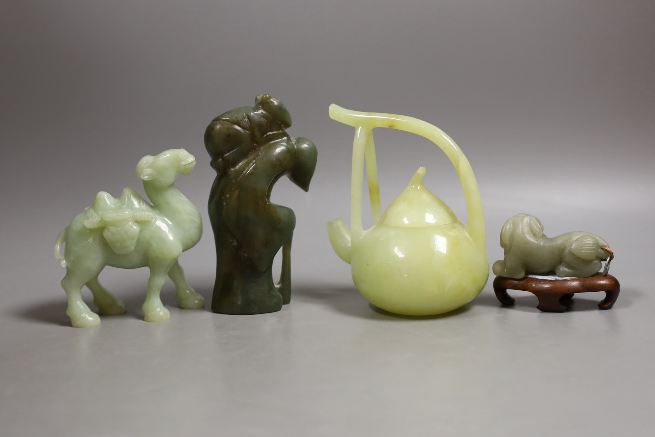 Three Chinese jade or hardstone figures and a bowenite jade wine pot, 12.2cm high (4)